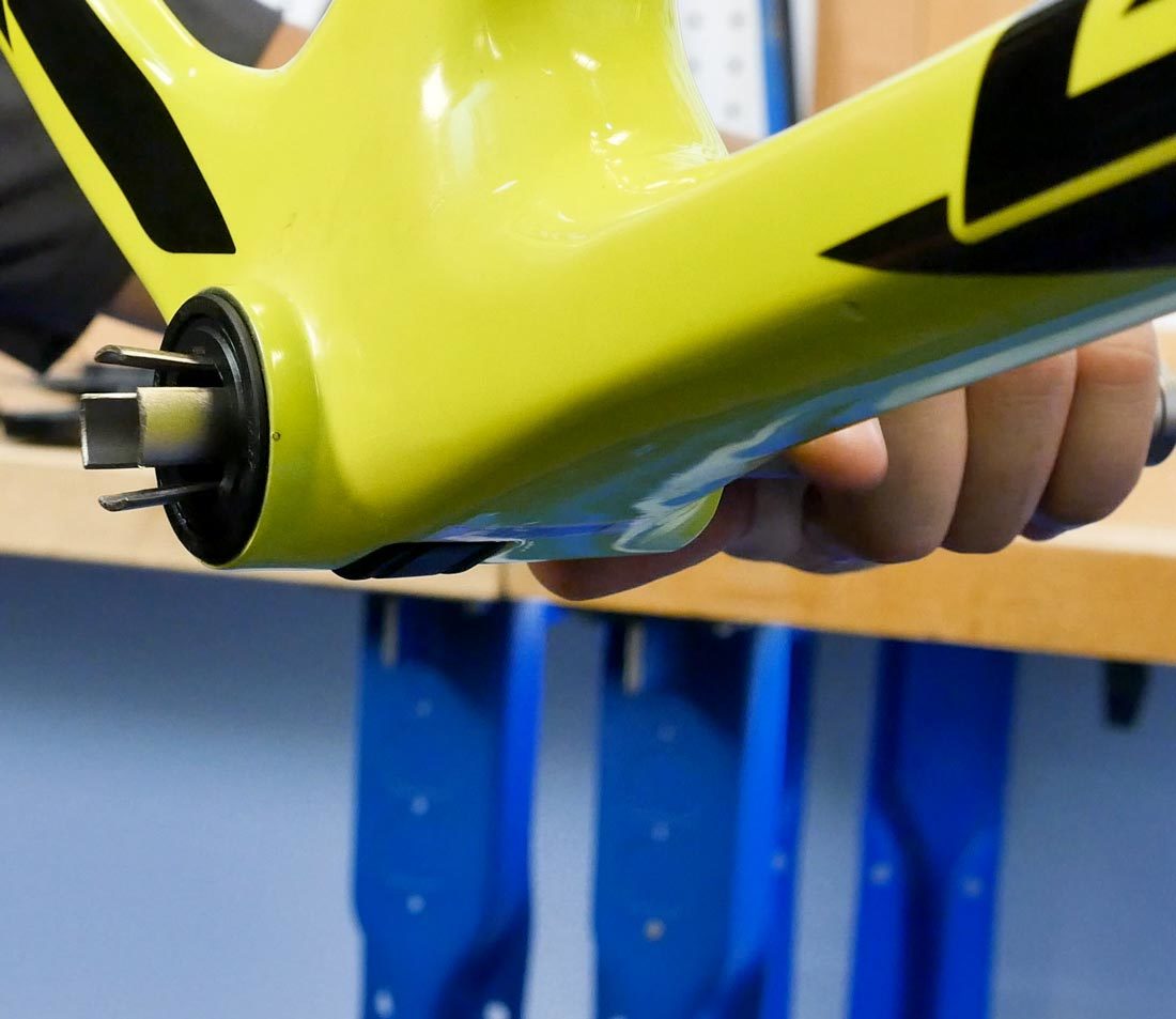 Drawing large end of the BBT-90.3 through a press fit bottom bracket cup on yellow bicycle frame