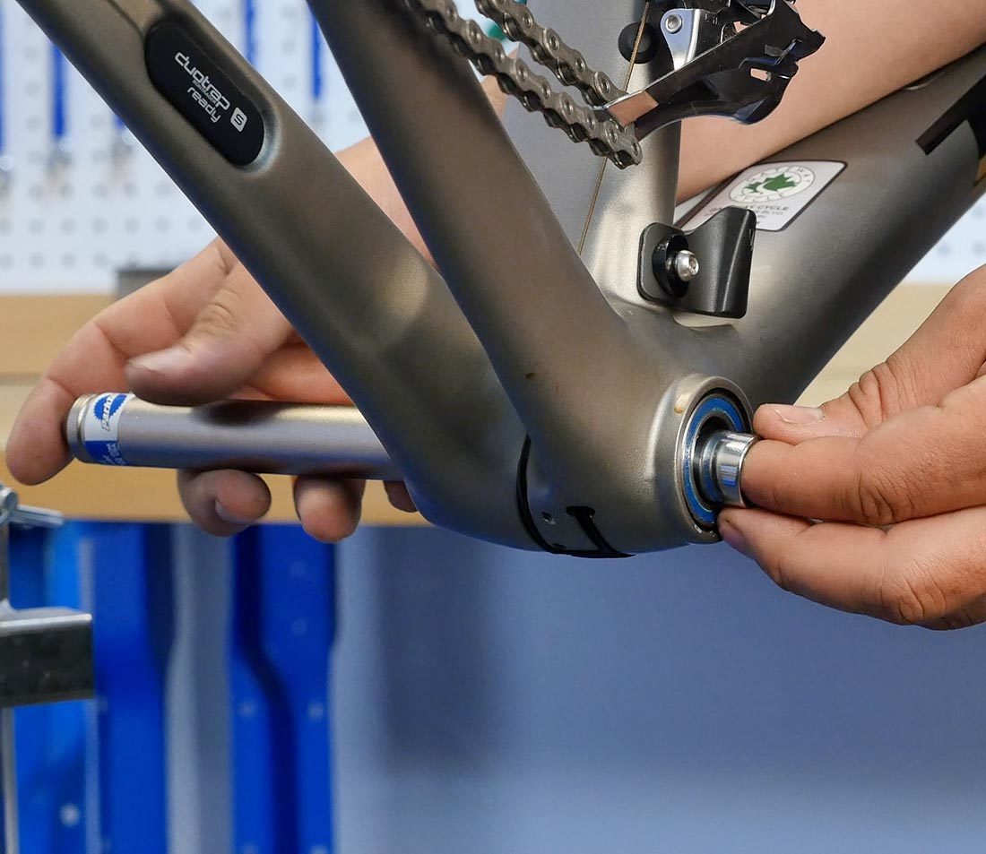 Inserting a plug into the bottom bracket bearing center to expand fingers of BBT-90.3 in the shell