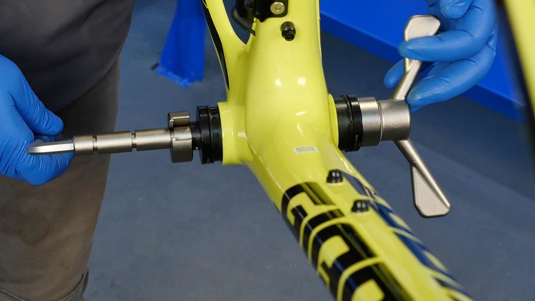 BBP-1.2 bottom bracket press inserted through frame shell installing press fit cups on both sides