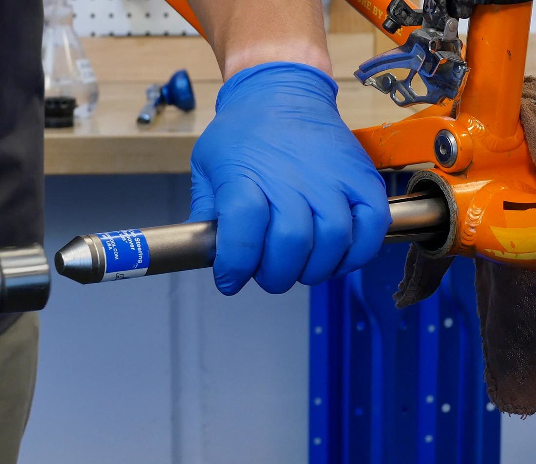 Hammer striking RT-1 in bottom bracket shell to remove pressed in non-drive side bottom bracket cup