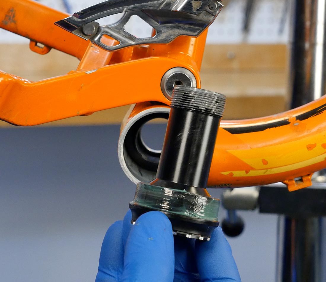 Drive side thread-together cup held in front of bottom bracket shell with grease and anti-seize applied