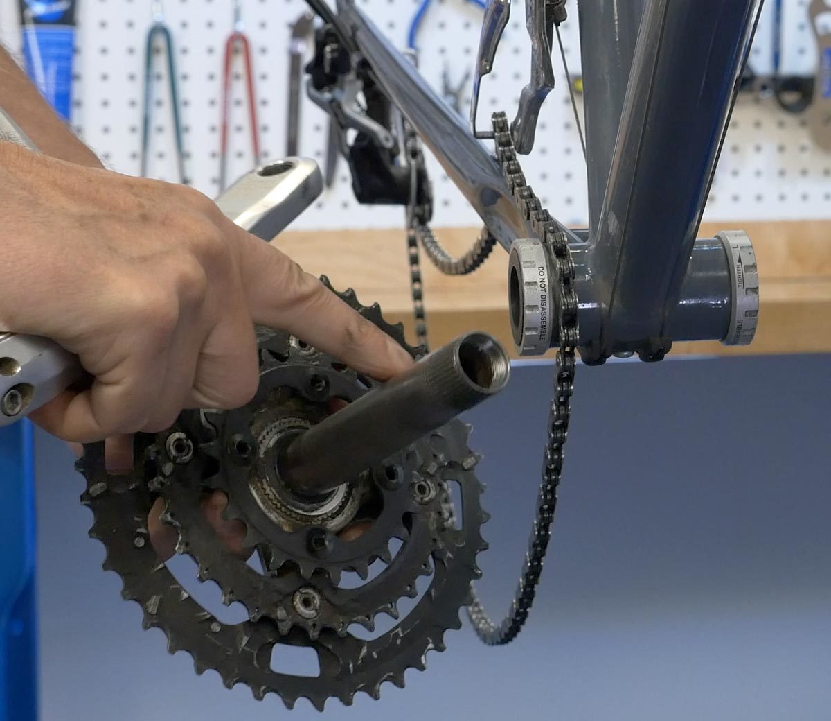 Drive side crank held next to thru-spindle bottom bracket shell with external cups