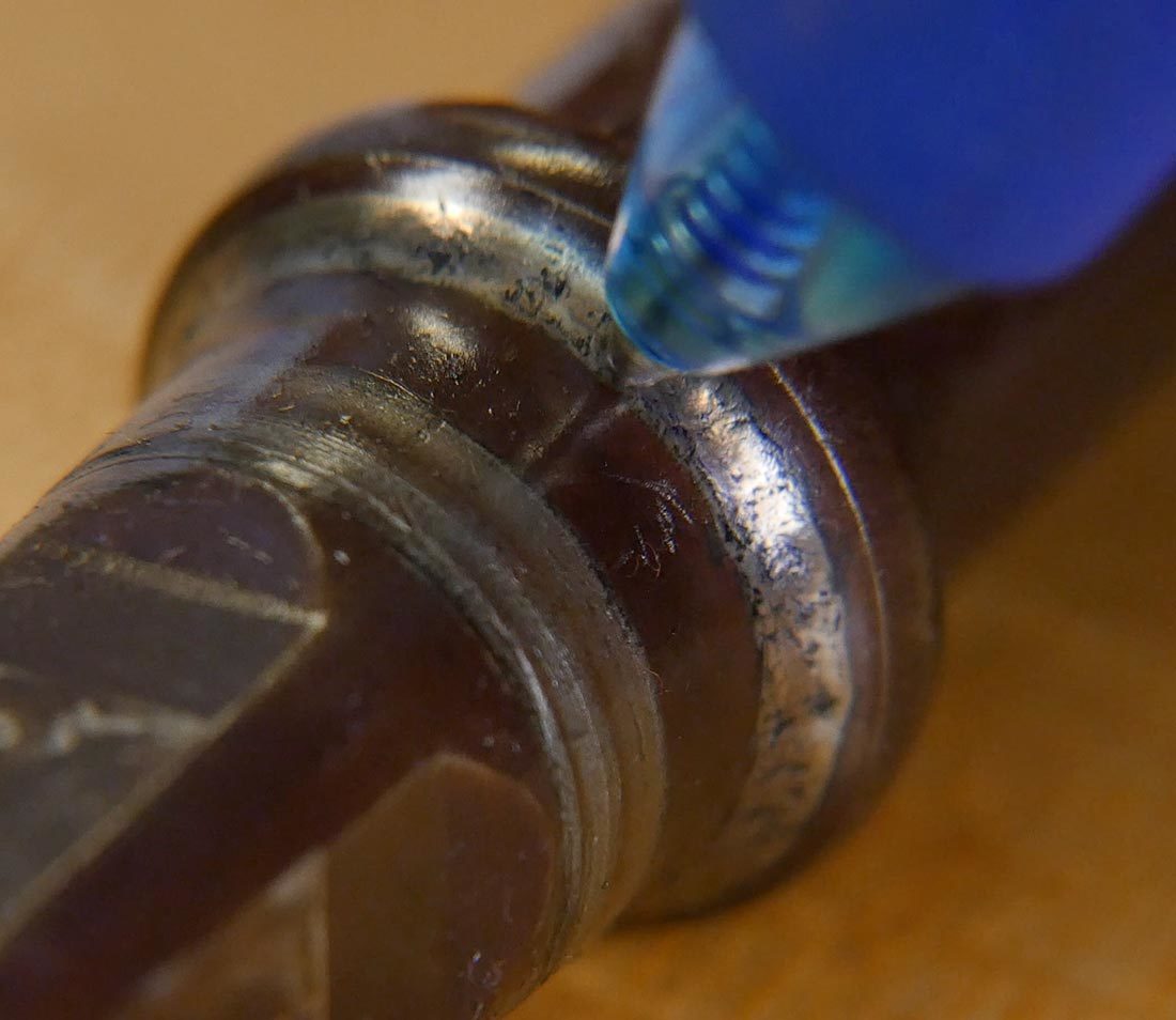 Closeup of ball point pen tip rolling over bearing surface of bottom bracket spindle