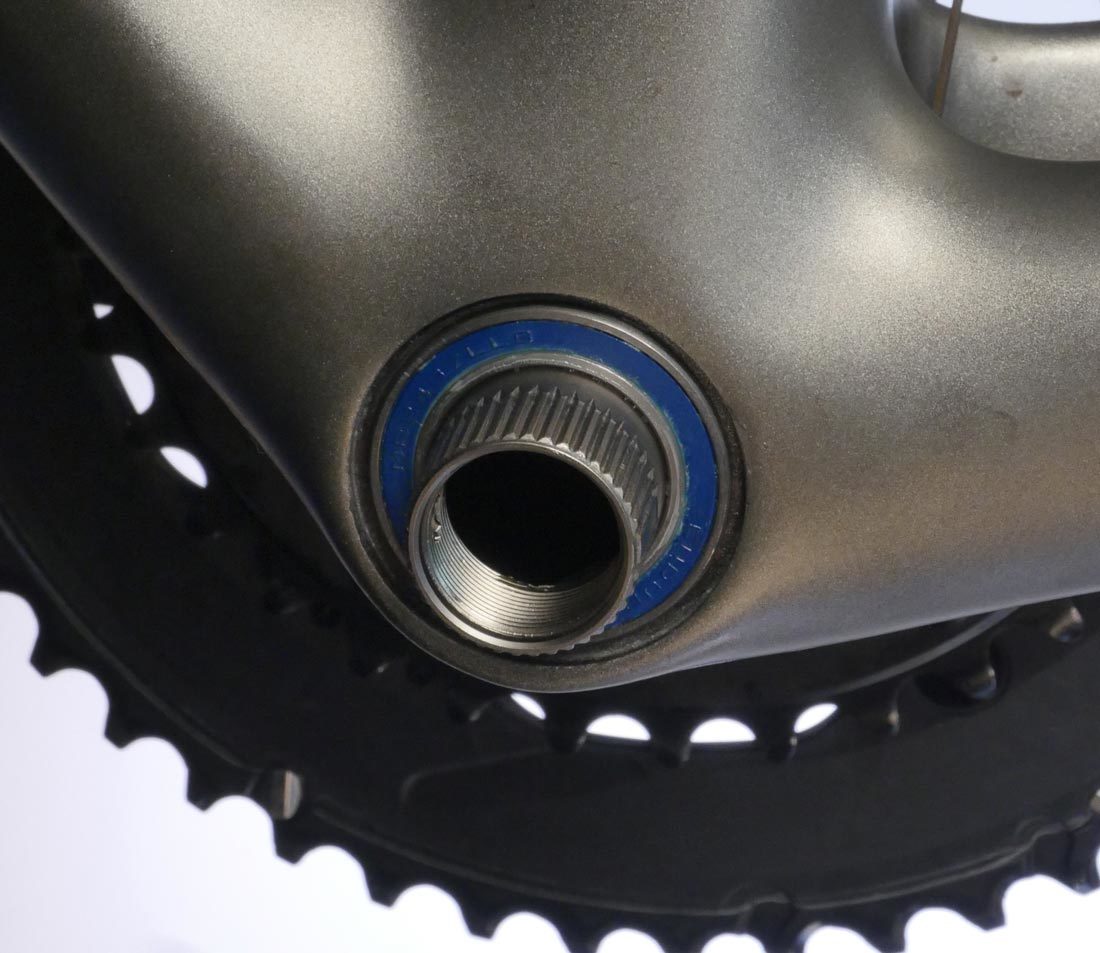 BB90 bottom bracket shell on carbon fiber frame with bearing installed and crank spindle inserted