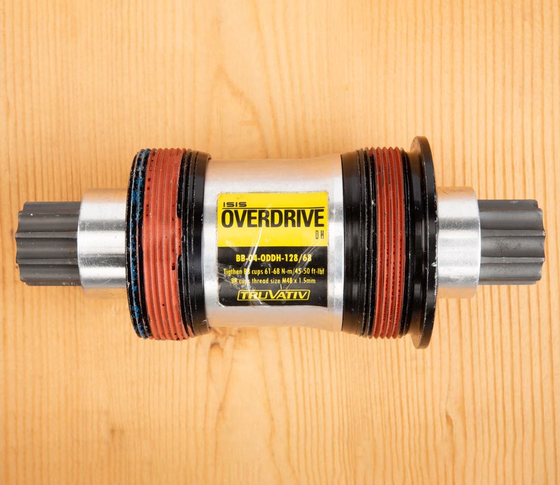 Closeup of ISIS Overdrive bottom bracket cartridge on wooden workbench