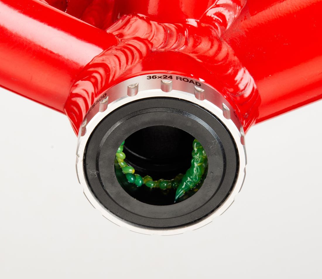 Italian Standard bottom bracket cup marked 36x24 installed on bottom bracket shell of red alloy bicycle frame