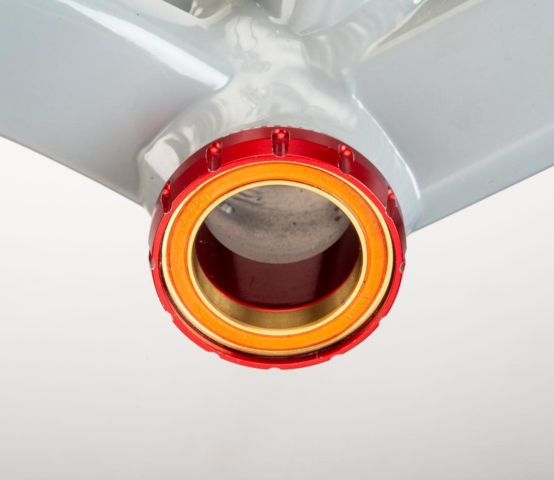 Threaded bottom bracket cup with 12 external notches, installed in bottom bracket shell on gray alloy frame