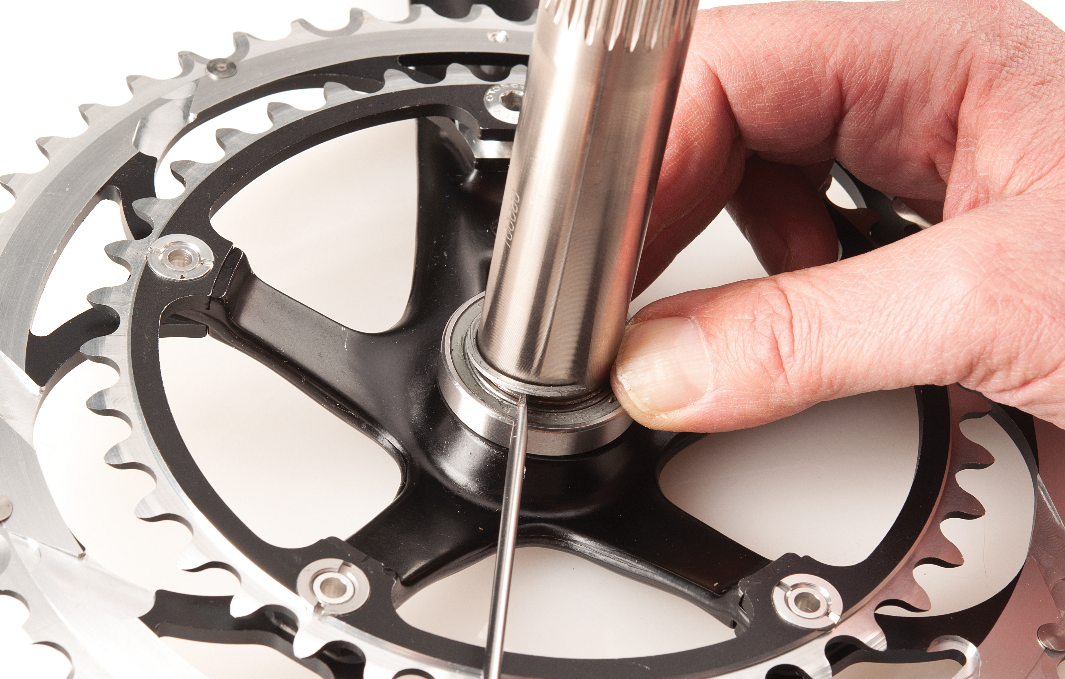 Carefully work free the C-clip on the drive side crank