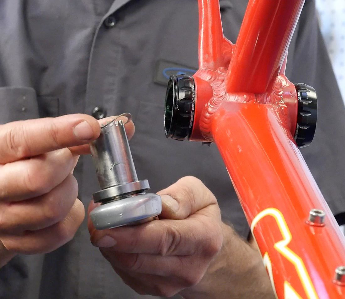 Installing wave washer onto non-drive side crank arm held next to bottom bracket shell with external cups