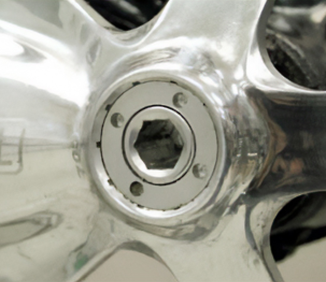 Self-extracting system with pin holes in retaining cap