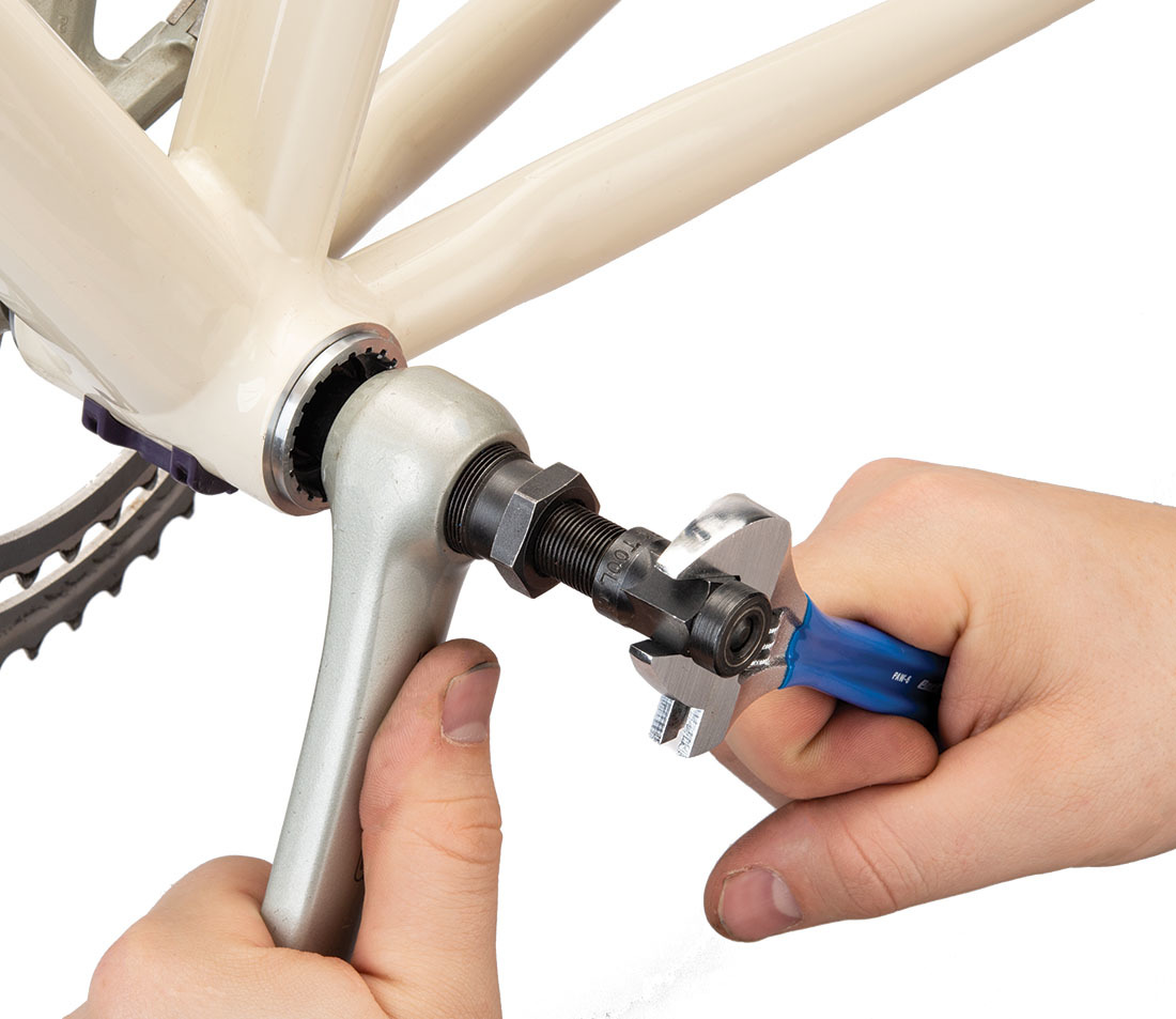 Turn handle to pull arm from spindle