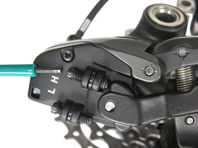 Figure 28. The outer shift limit (H-screw) must contact linkage