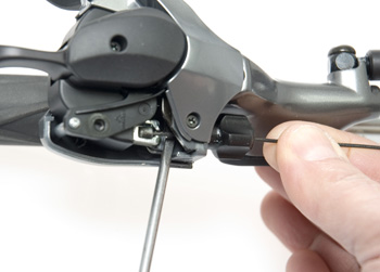 Pry the shift cable out with a small flathead screwdriver