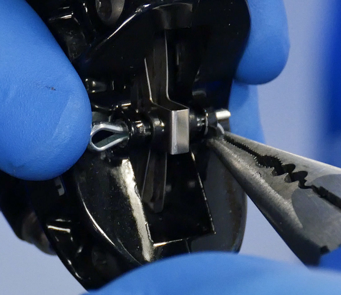Bending cotter pin to remove from hydraulic brake caliper
