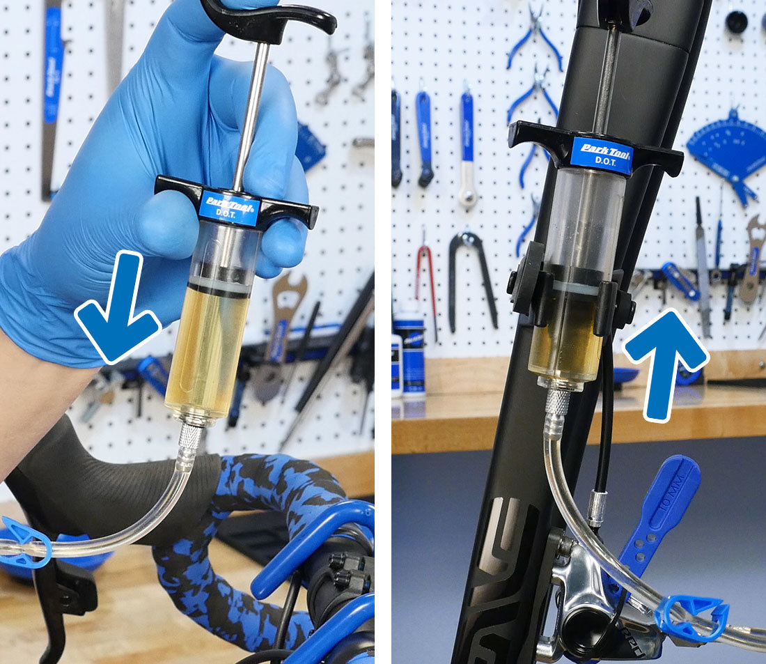 Clean brake fluid being pushed out of the upper syringe and dirty fluid entering the lower syringe