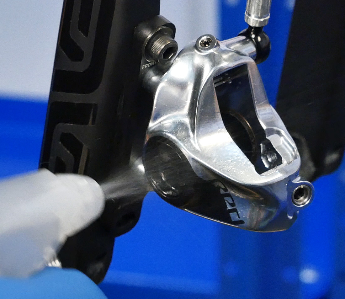 Brake caliper being sprayed with rubbing alcohol