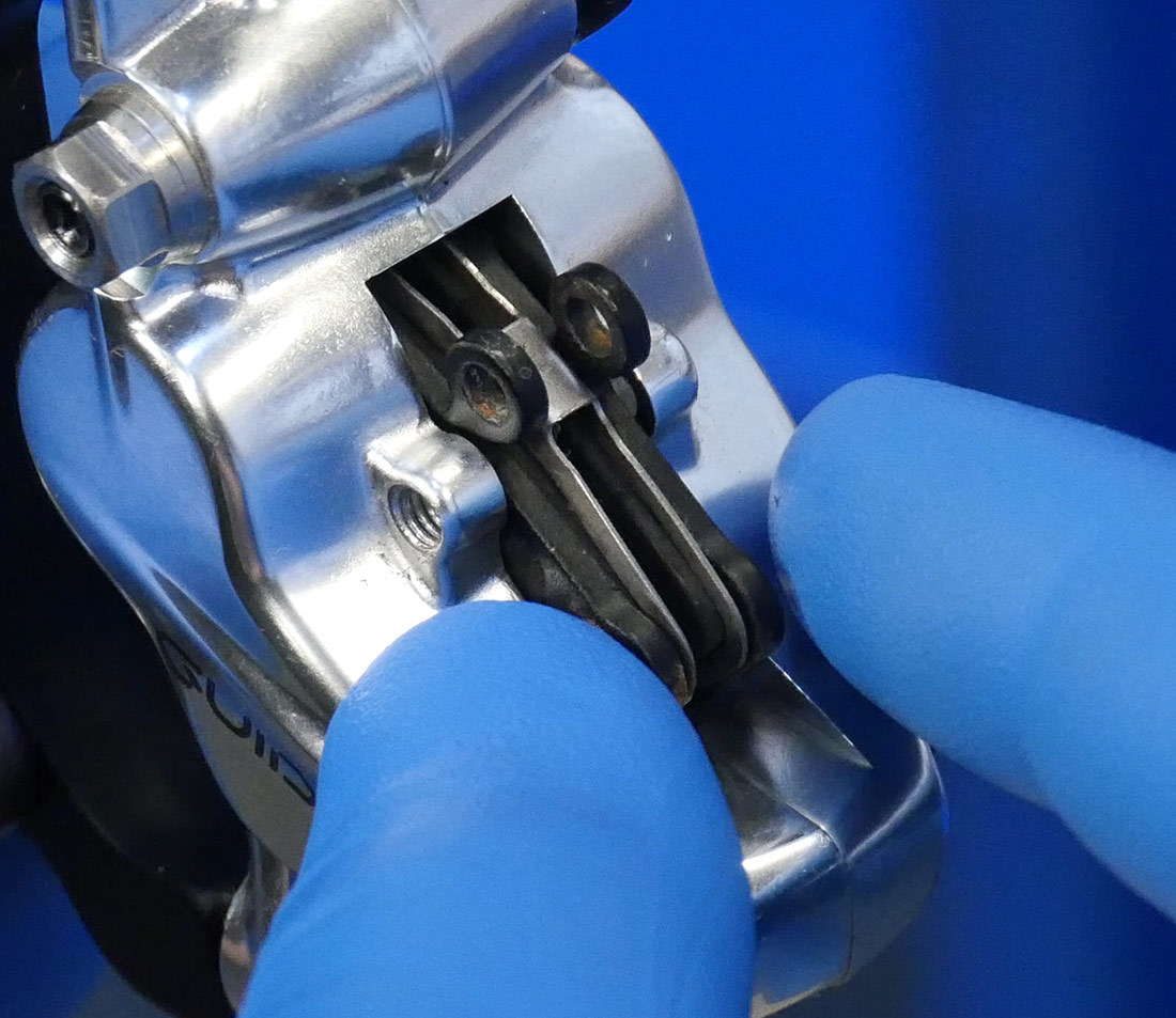Removing brake pads from hydraulic brake caliper by hand