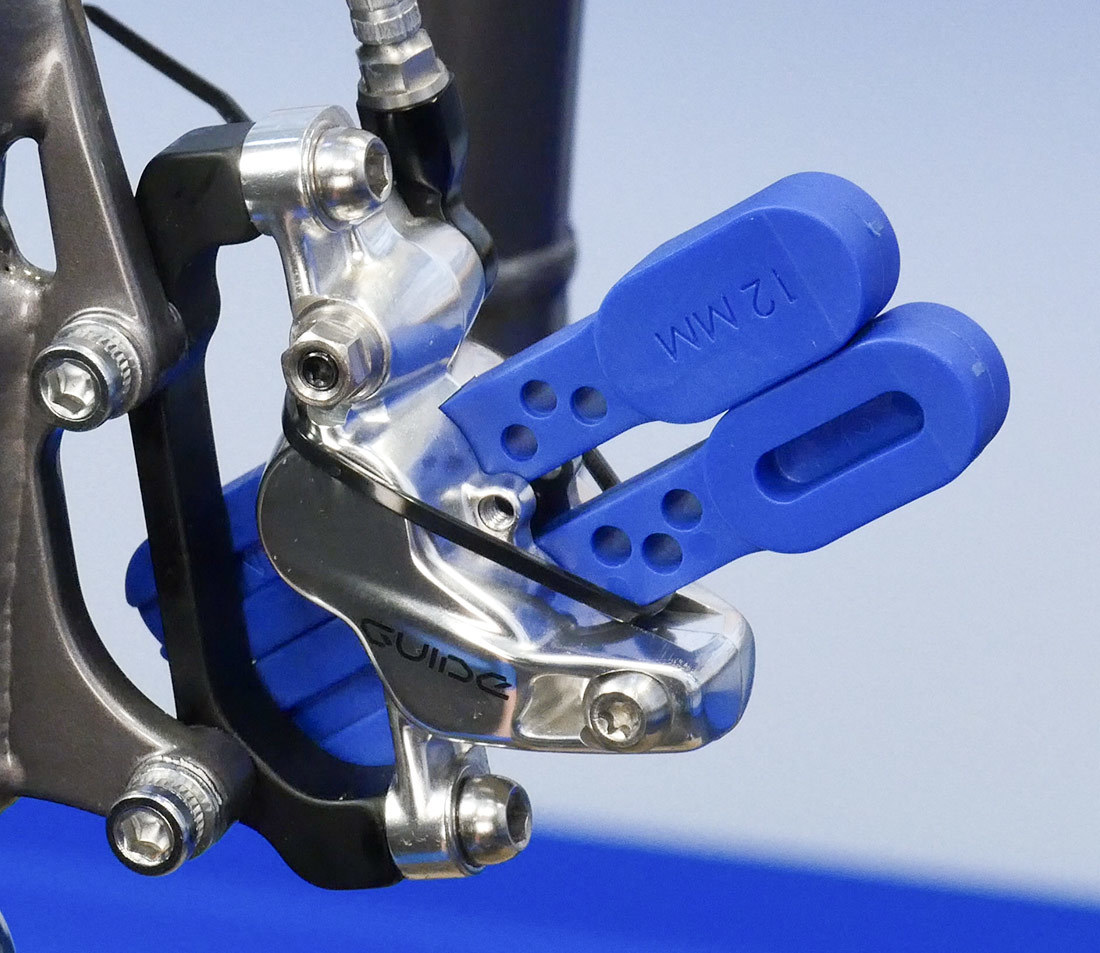 Two bleed blocks installed into a hydraulic brake caliper on a rigid bicycle fork