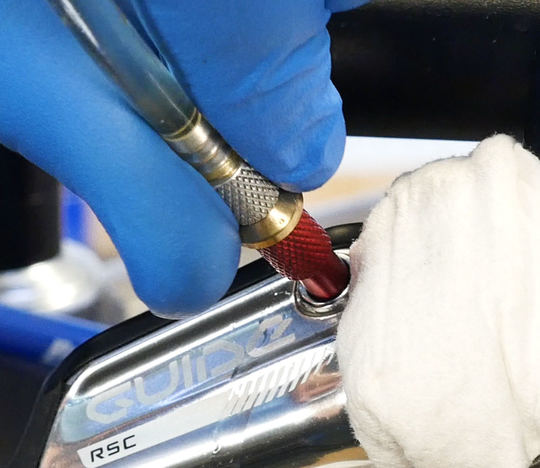 Adaptor end of syringe hose being installed into brake lever bleed port