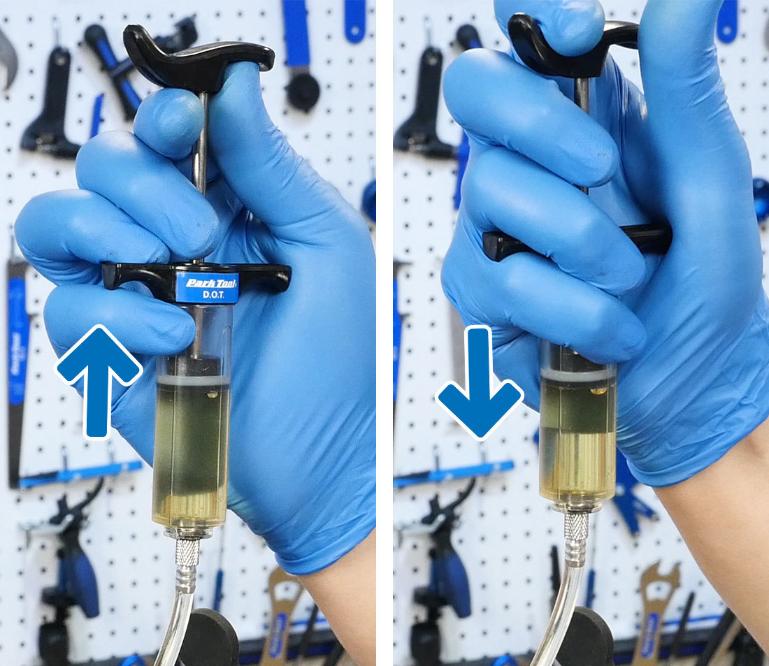 Bleed syringe being held in hand and the plunger pulled, then pushed
