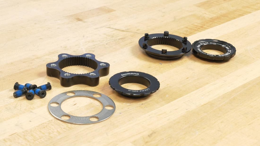 Two examples of a 6-bolt-to-center-lock adapter: Shimano (L) and DT Swiss (R)