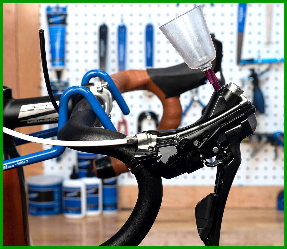 Shimano top port brake lever on drop handlebars with hood removed to show integrated metal tubing