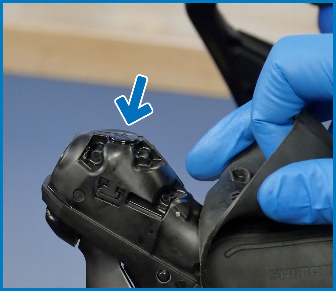 Shimano top port brake lever on drop handebars with hood pulled back to expose port for brake bleeding