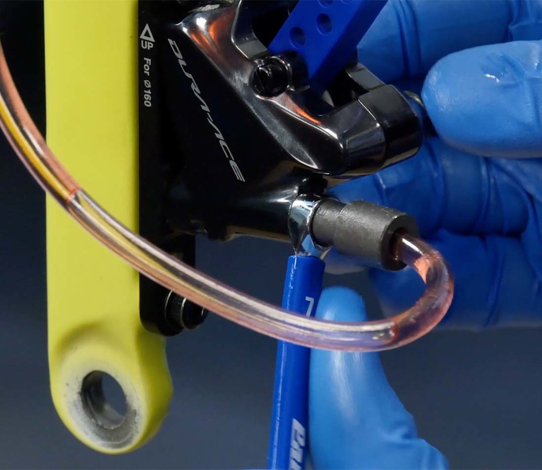 Bleed hose compression sleeve installed onto caliper nipple with metric box wrench