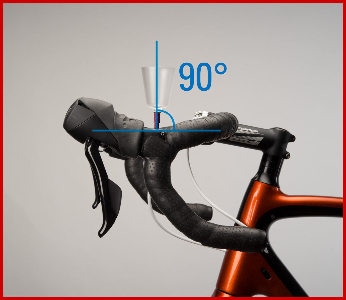 Bleed funnel installed into brake lever with drop handlebars rotated so funnel is 90 degrees vertical