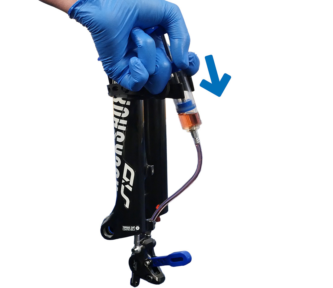 Push fluid from the syringe through the system