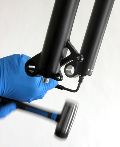 Figure 2. Use a hammer to drive bolt back into legs