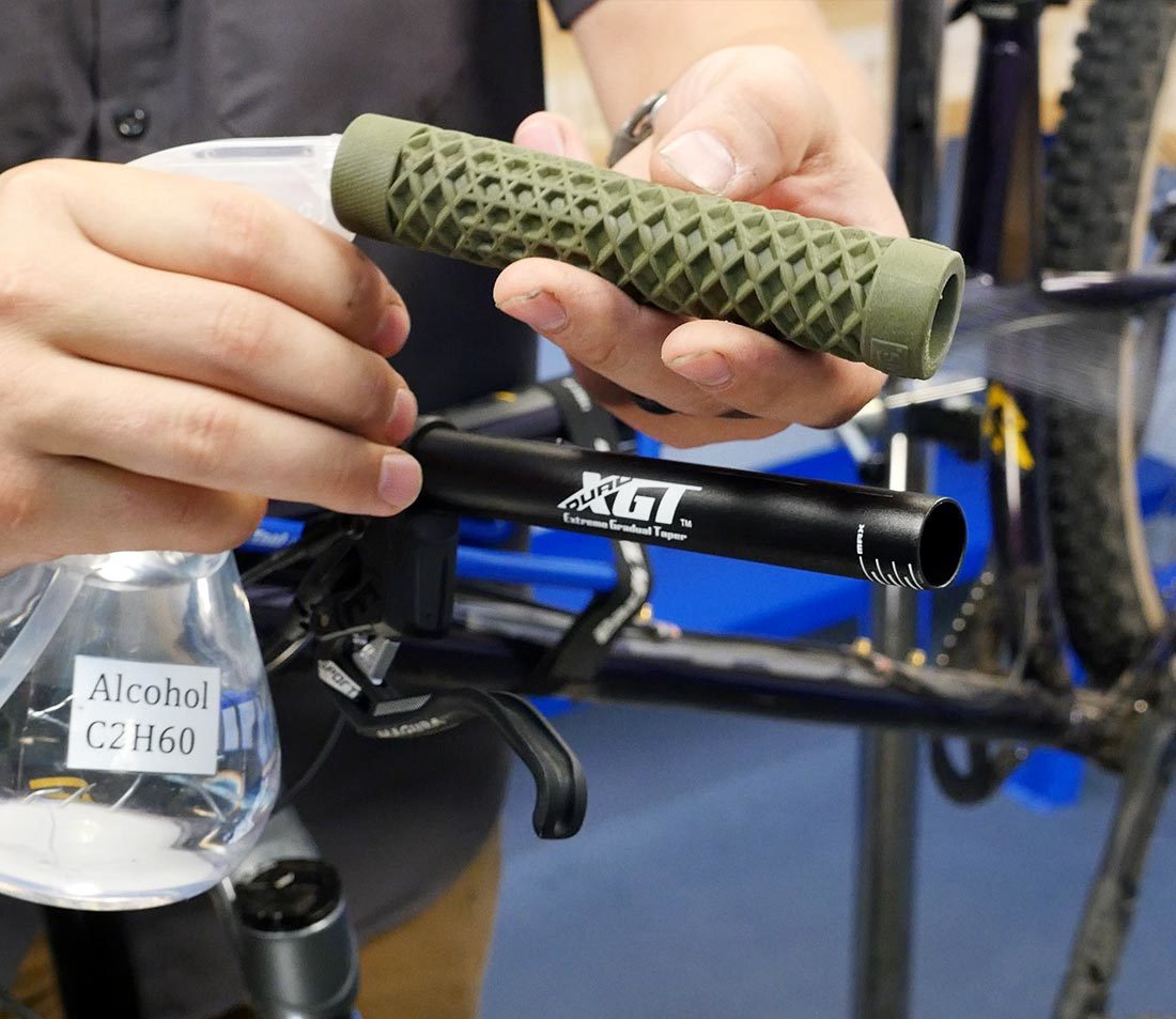 Spray inside the grip and onto the bar