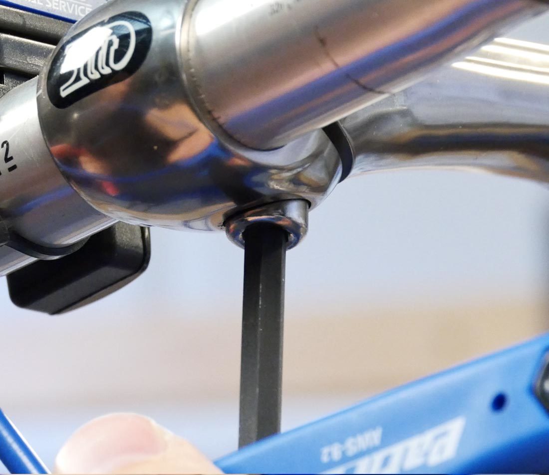 Loosen compression slot bolt enough to remove bar