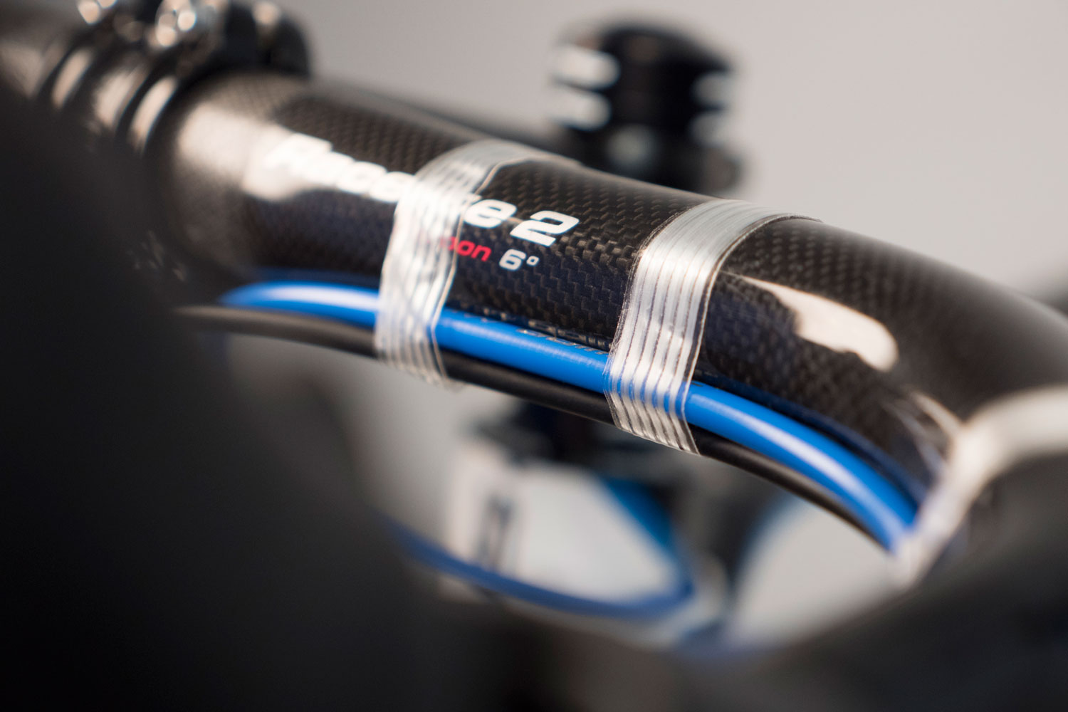 Secure housing to handlebars in preparation of wrapping
