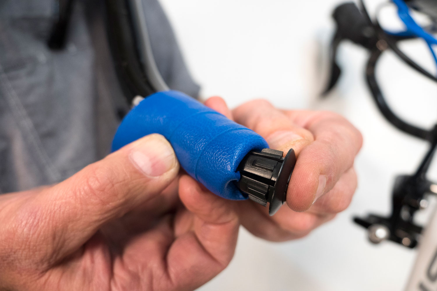 Tuck the tape into the bar end and insert plug