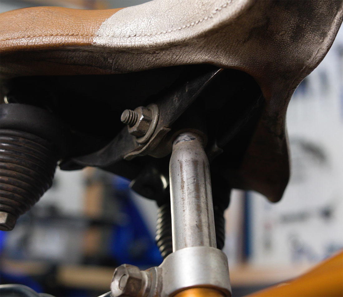 An old-school stamped steel saddle with flat rails