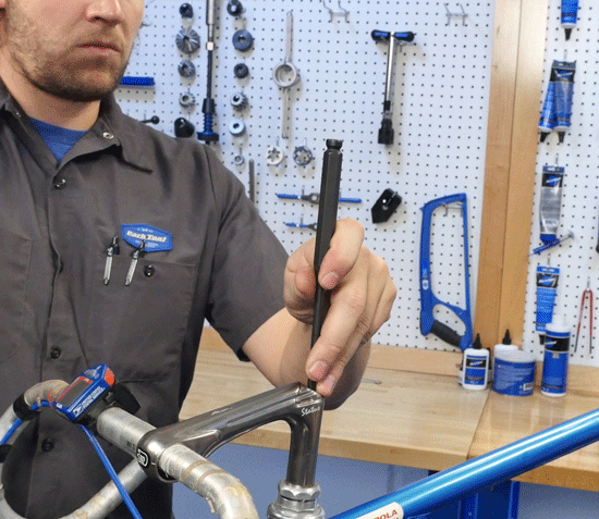 If quill is jammed, lightly strike stem binder bolt with punch and hammer
