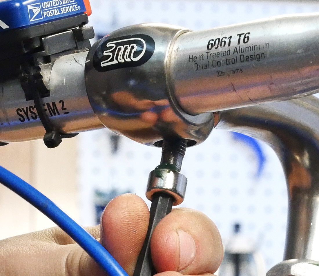 Grease and install compression slot bolt