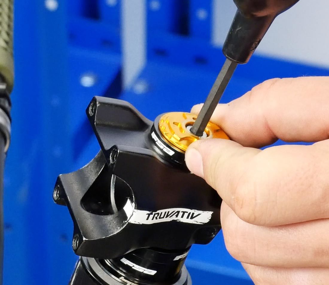 Tighten the top cap until you meet resistance