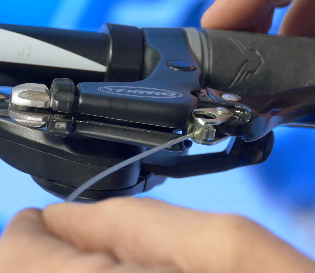 Install cable end in lever and engage cable through slot in lever body