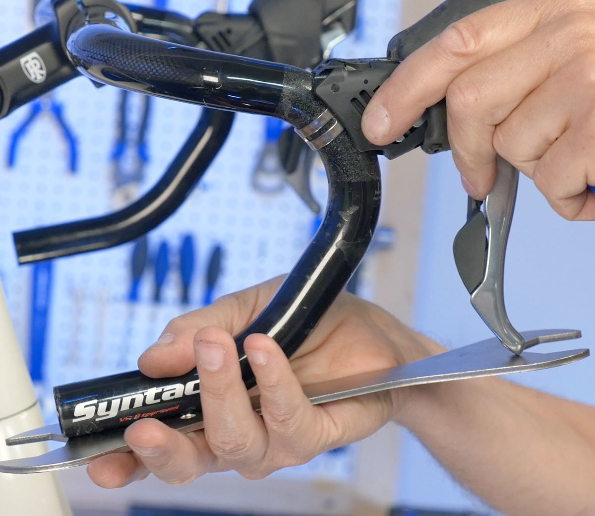 Begin alignment with lever tip even with straight edge off bar