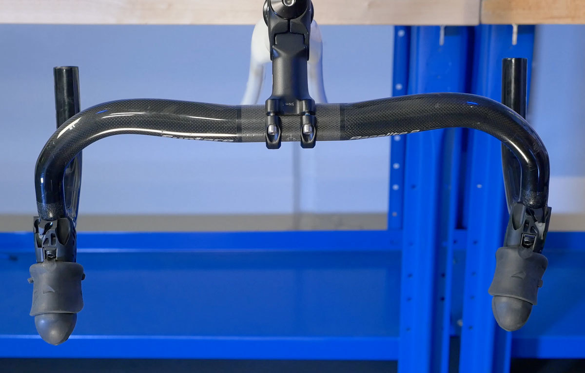 Sight bars from above and rotate so both are parallel to one another. Lever of riders left is too far inward.