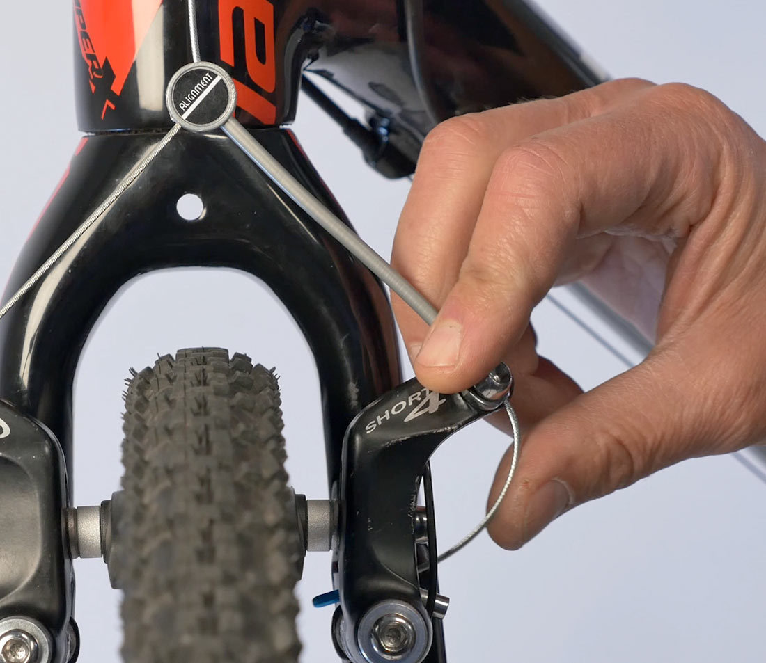 Tuck cable into brake