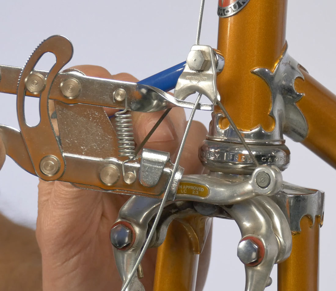 Pull pads to rim and secure saddle wire carrier pinch bolt