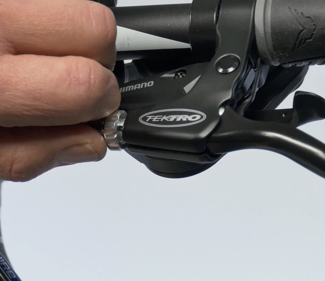 Use barrel adjuster to set tightness of pads to rim