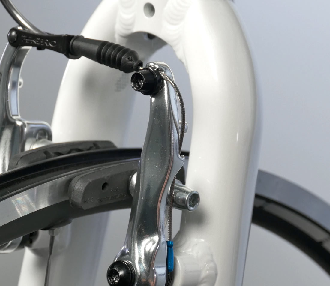 Tuck extra cable back into brake caliper