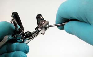 Release spring from caliper arm