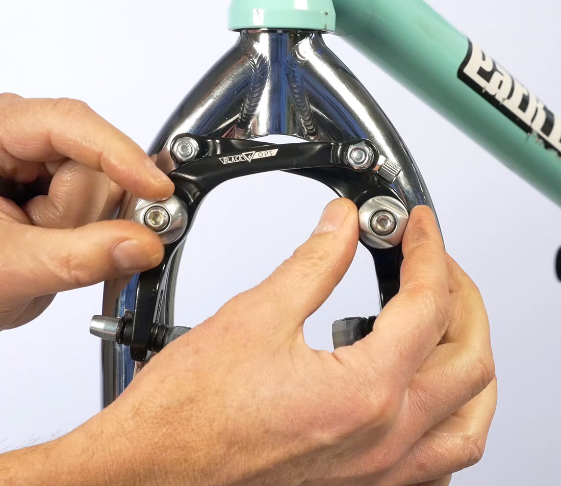 Spring tension is controlled by these brake arm fittings