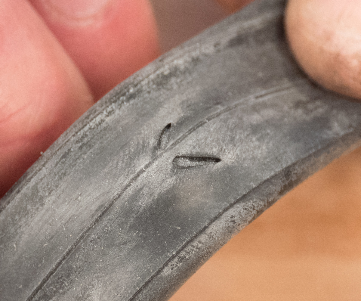 Symmetrical slits are indicative of a rim pinch