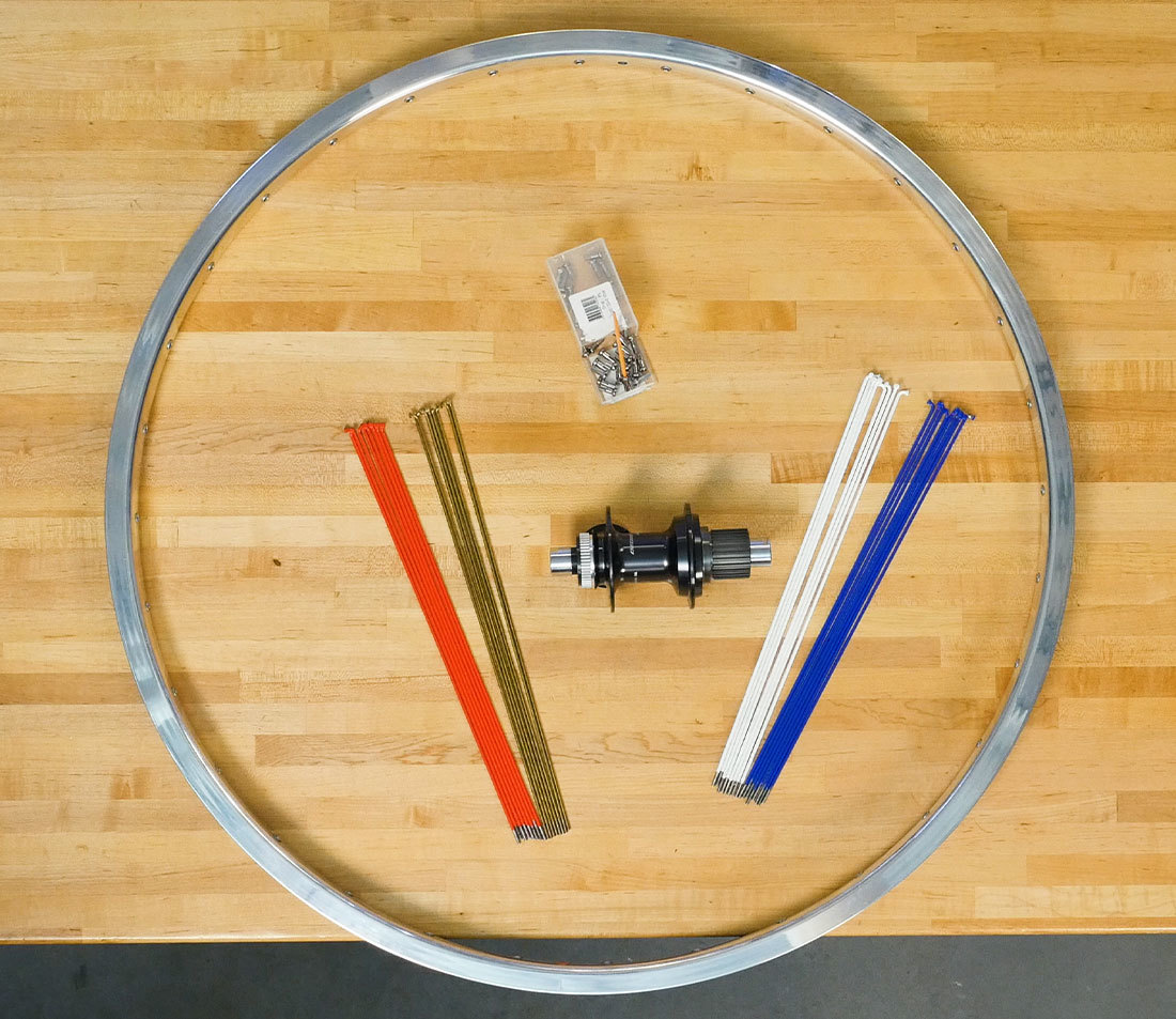 Workbench with all components laid out and organized for building a wheel